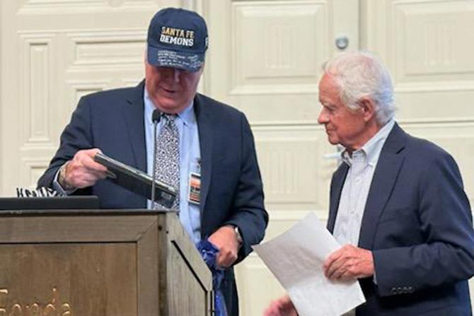 Max Myers presents John Anderson with gifts at the President’s Dinner.